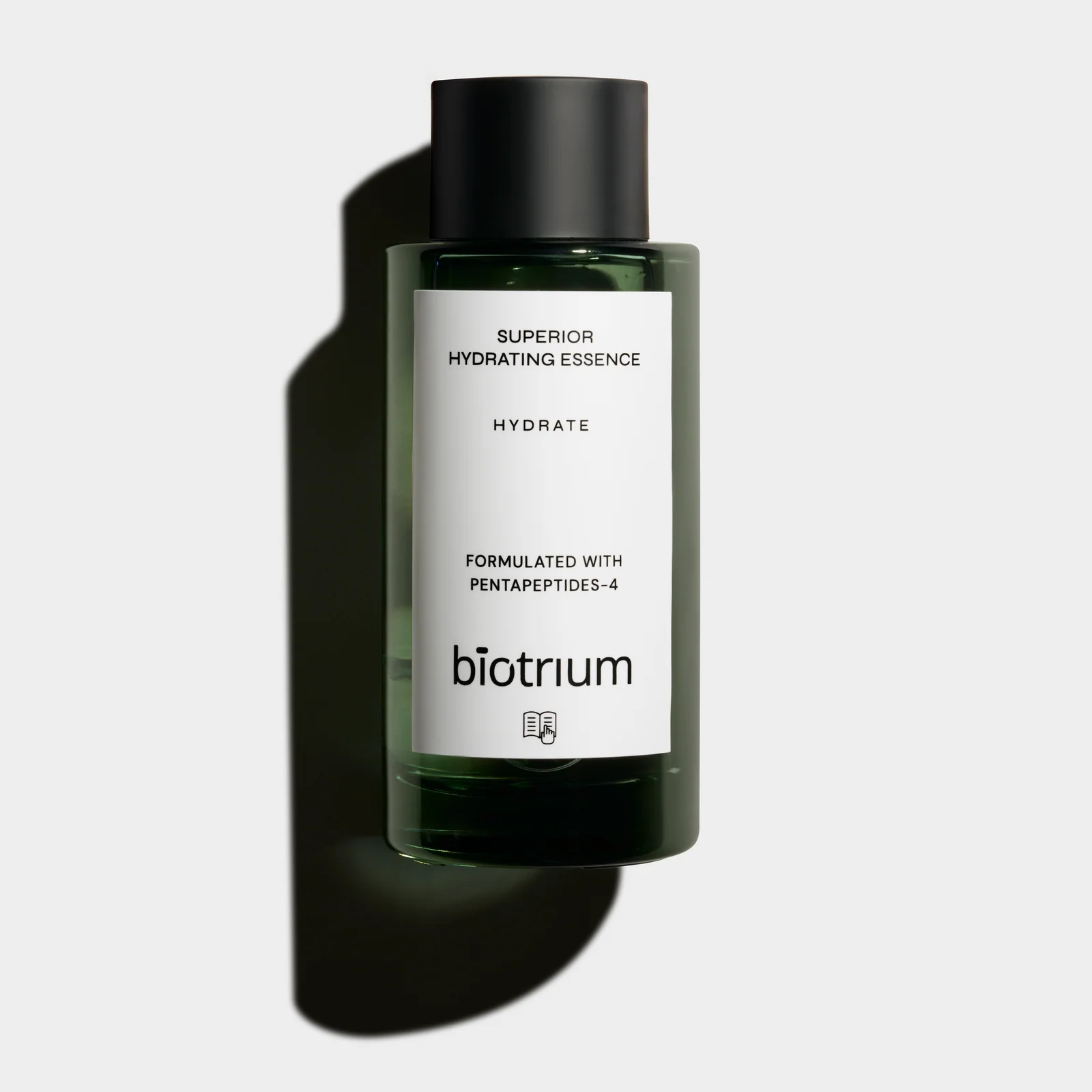 Front view of a green Biotrium Hydrating Essence bottle with a black cap and a defined shadow on a light background.