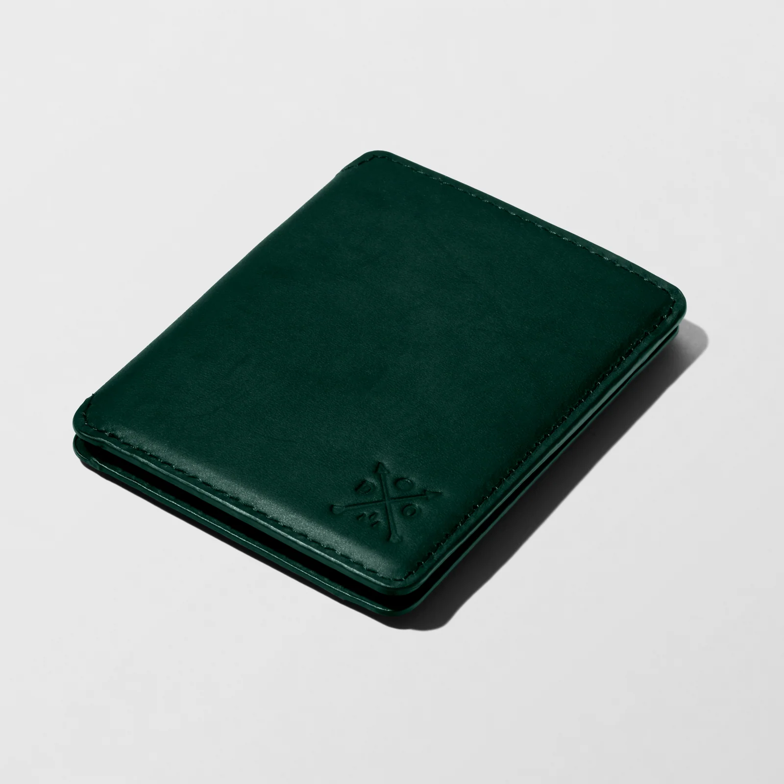 Closed green Double Oak leather wallet photographed at an angle on a light background.