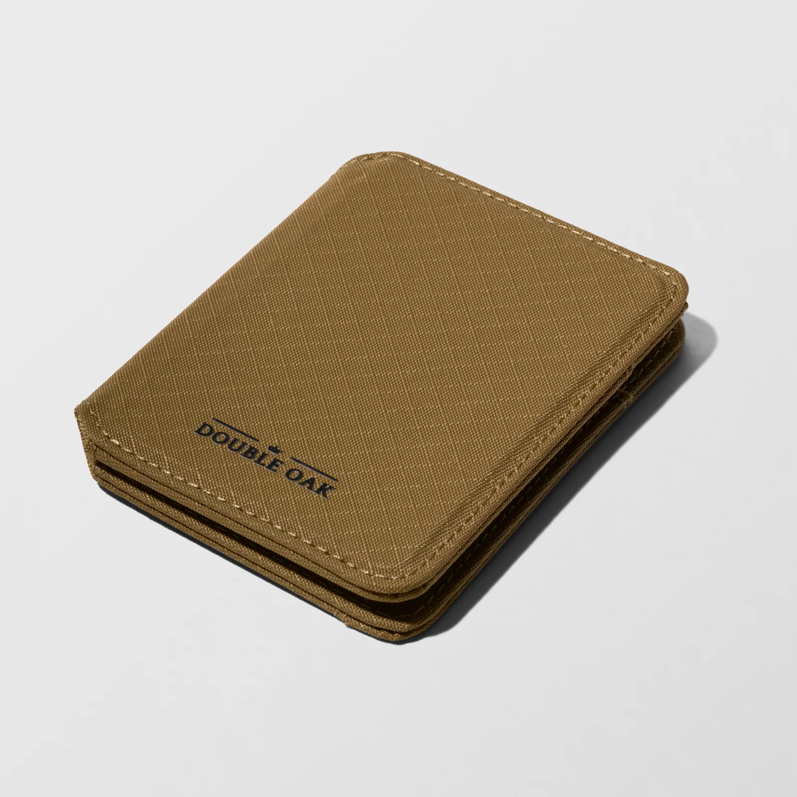 Closed khaki Double Oak fabric wallet photographed at an angle on a light background.