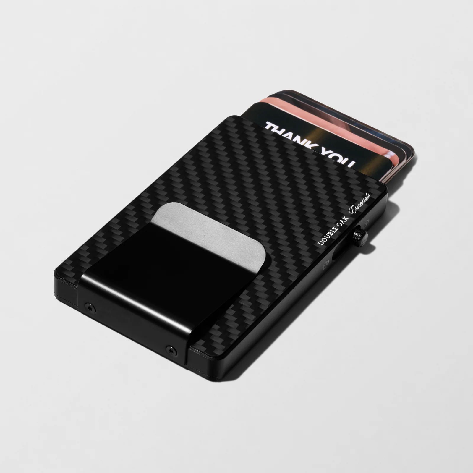 Black patterned Double Oak cardholder with raised cards and a silver-coloured clip on a light background.