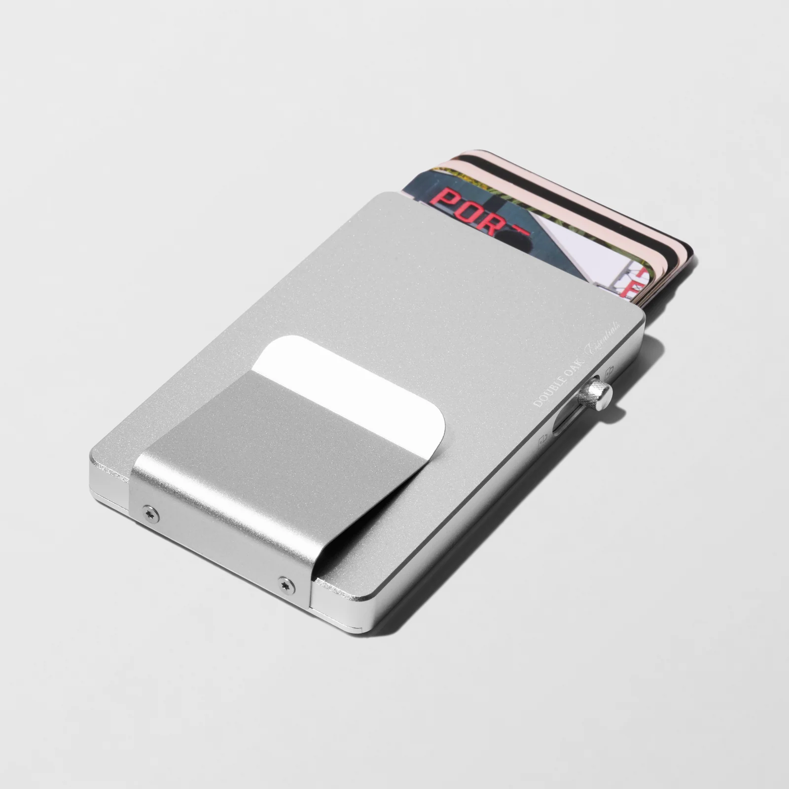 Silver-coloured Double Oak cardholder with raised cards and a matching clip on a light background.