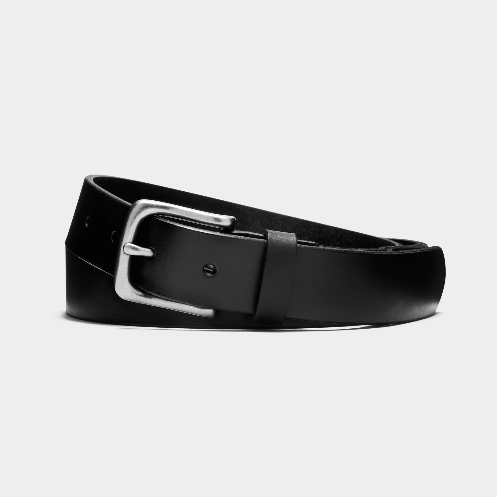 Black Double Oak leather belt with a silver-coloured buckle, loosely coiled on a light background.