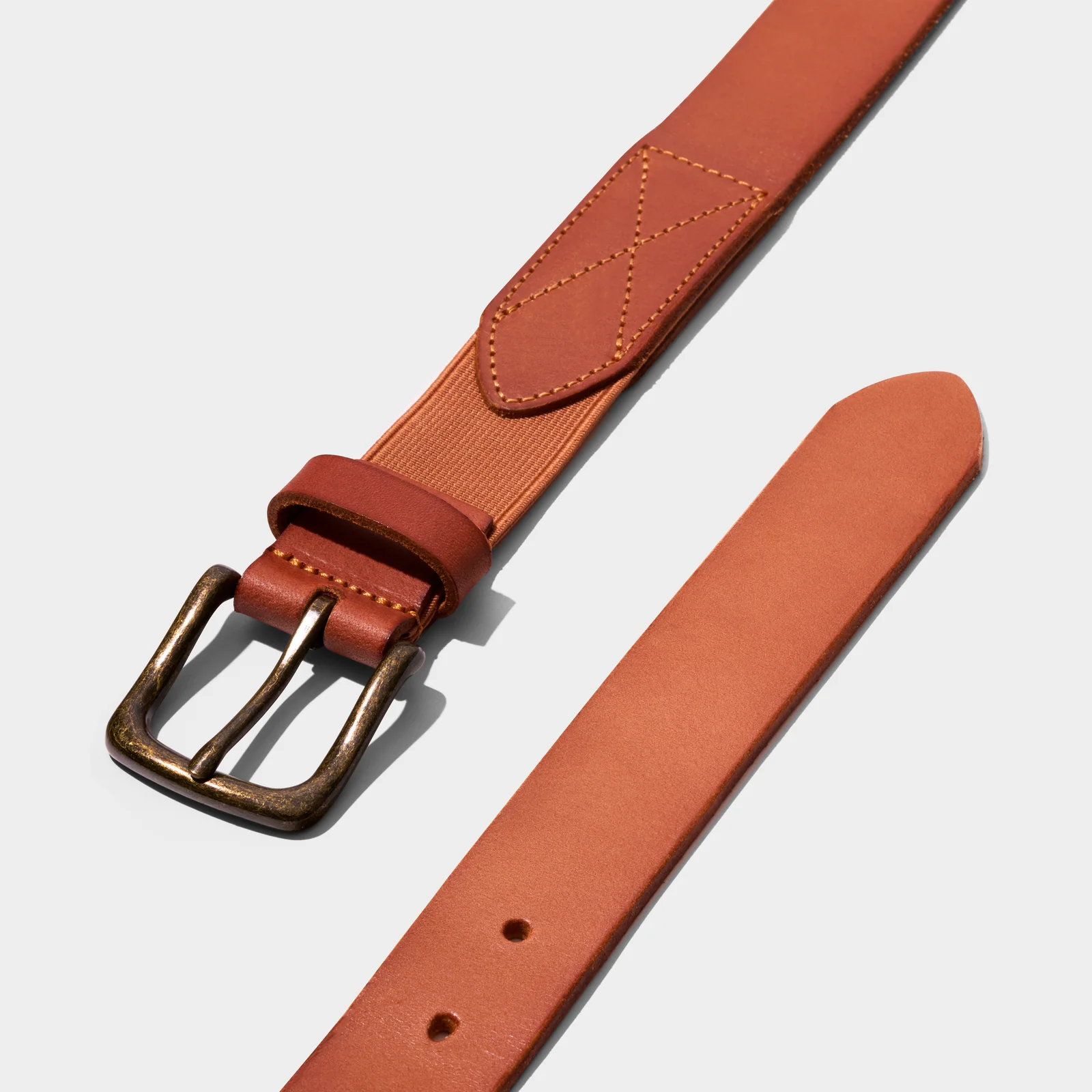 Both ends of a brown Double Oak belt showing the buckle, stitched attachment and adjustment holes.