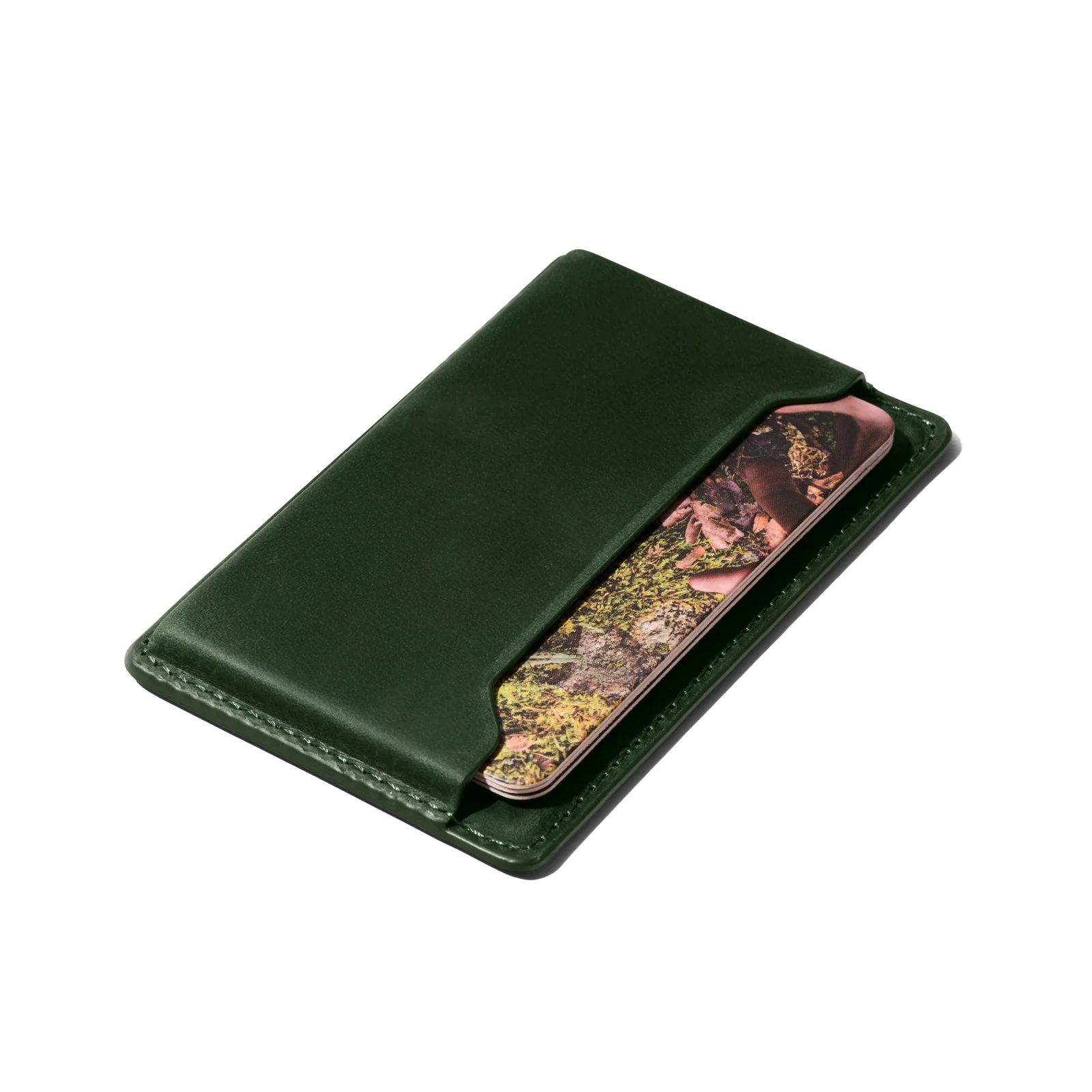 Green Double Oak leather wallet with a patterned card visible in its outer pocket on white.