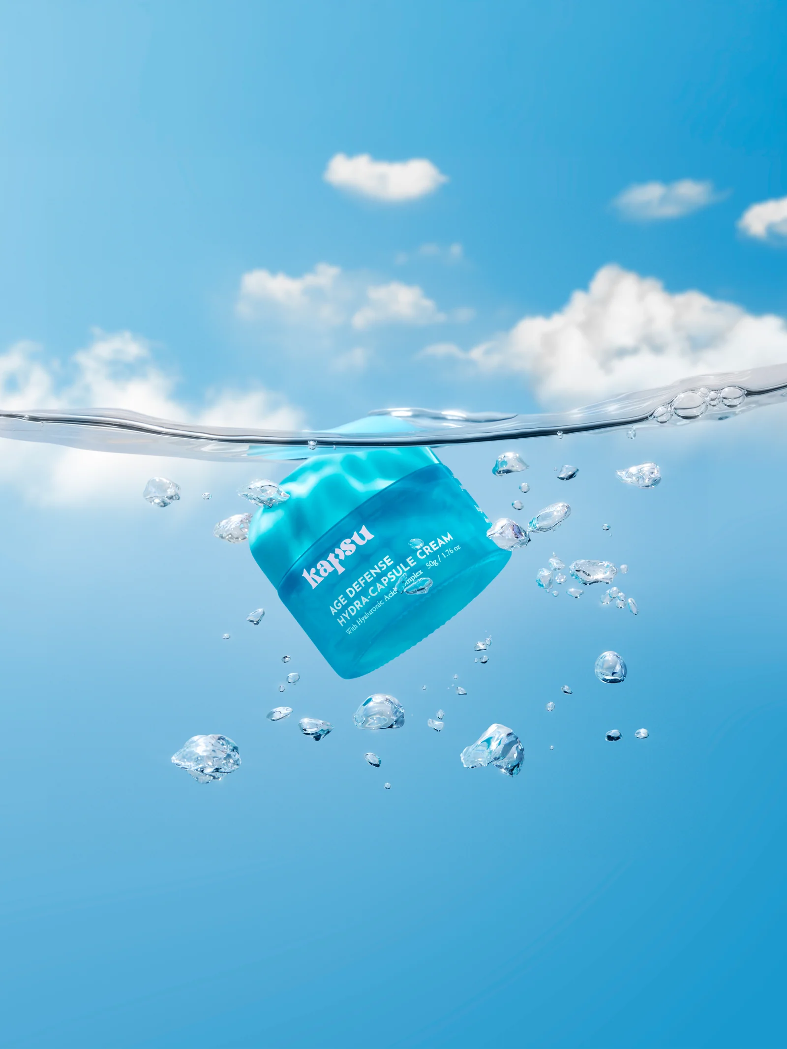 Kapsu skincare jar suspended below a clear waterline with bubbles drifting around it.