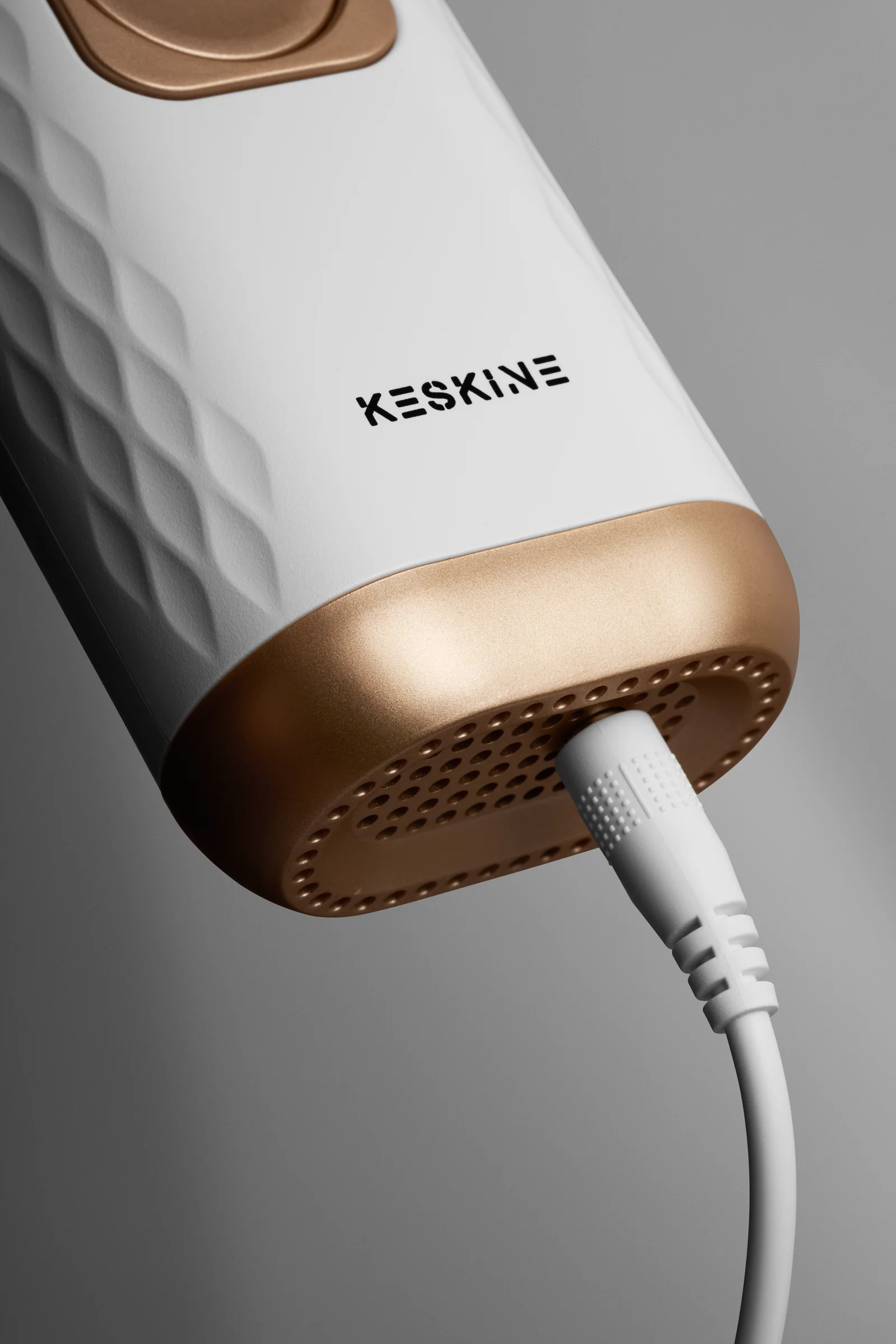 Close-up of the Keskine IPL device base with its power cable connected.