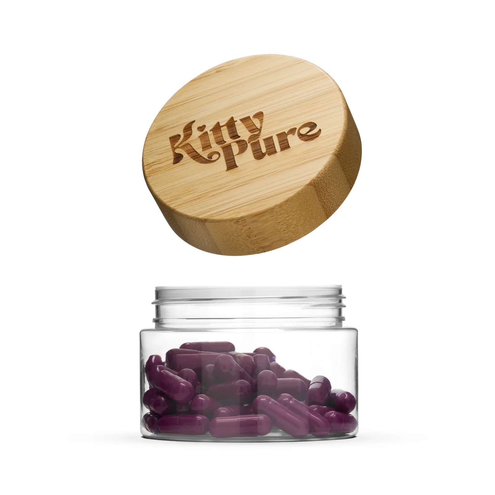 Clear jar of purple KittyPure capsules with its branded wooden lid suspended above against white.