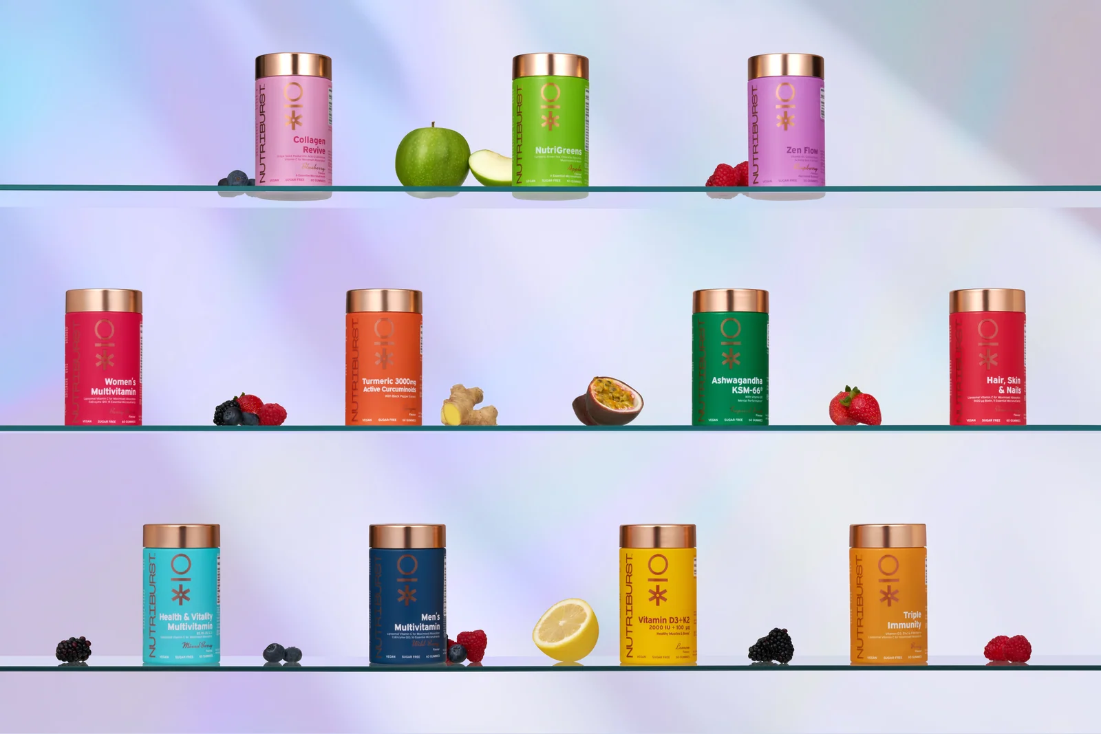 Nutriburst jars and fruit arranged across three glass shelves against a softly coloured background.