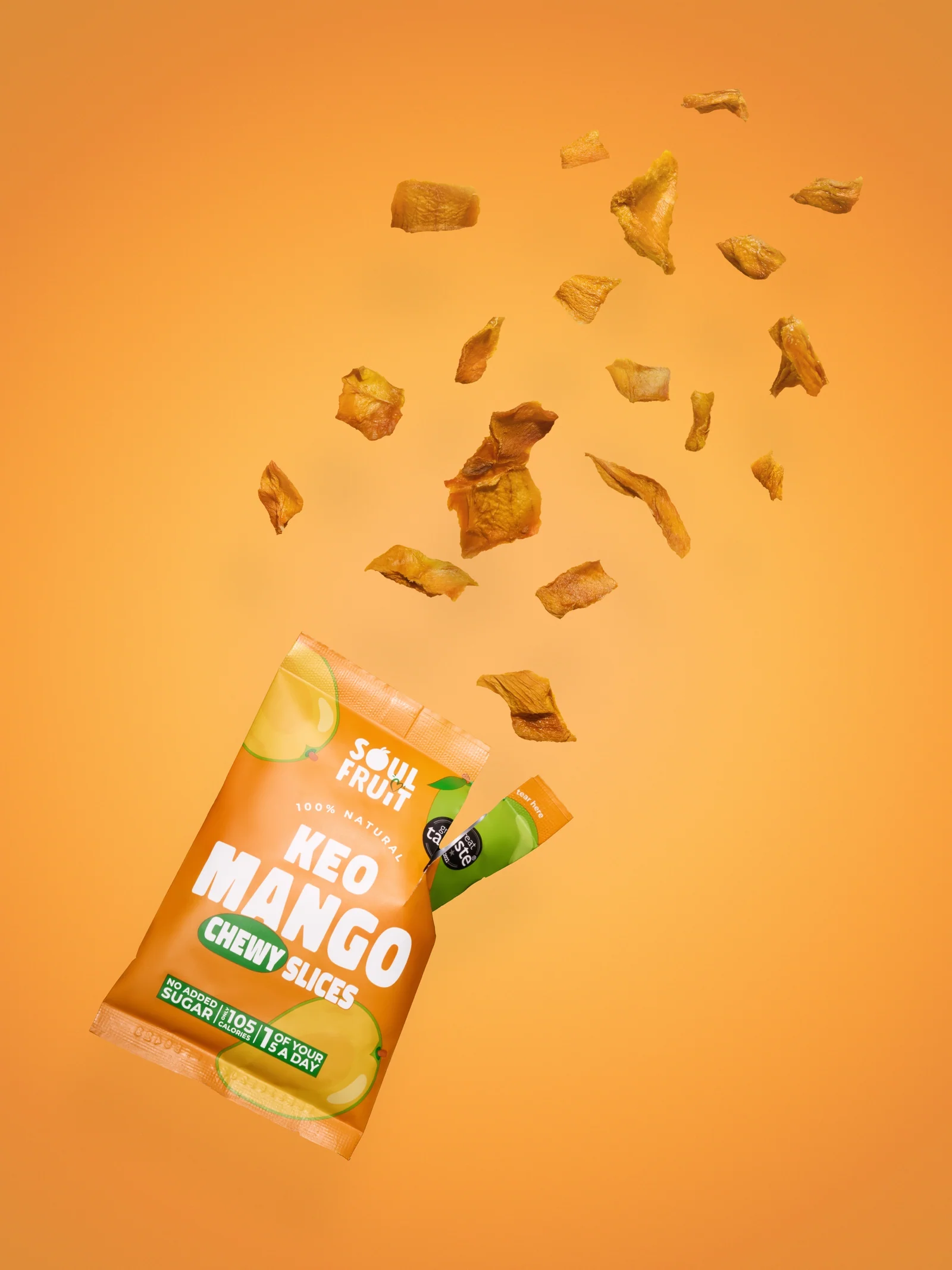 Soul Fruit Keo Mango Chewy Slices packet with mango pieces bursting out against orange.