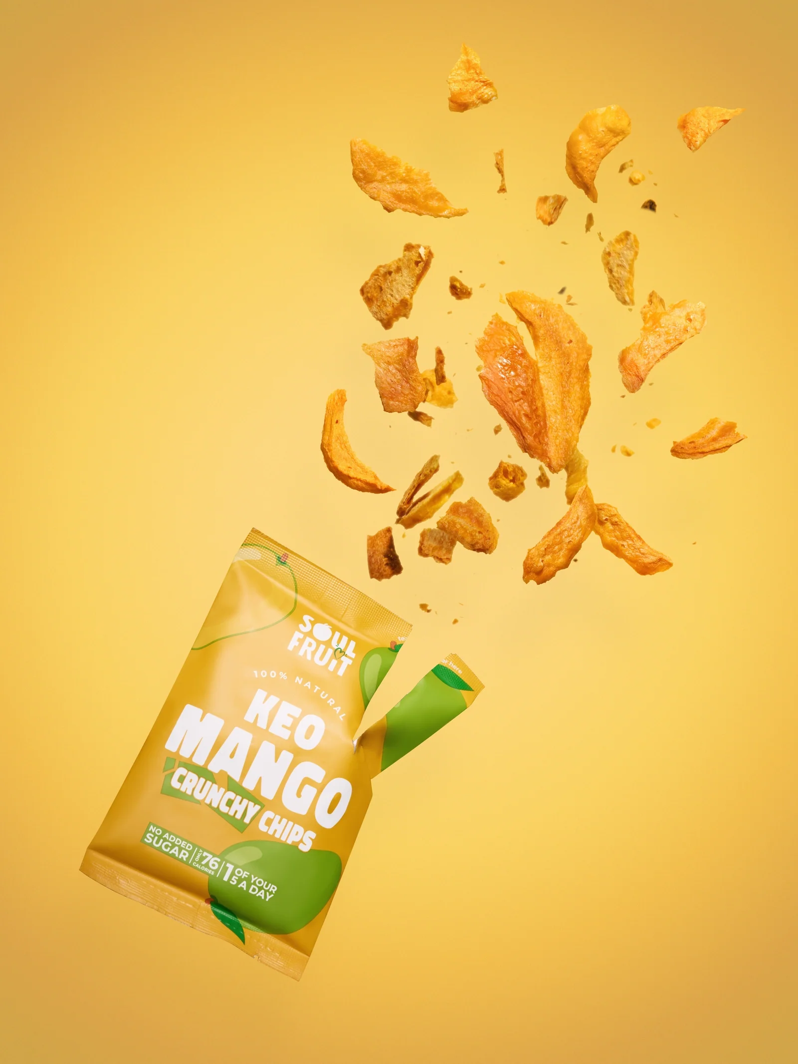 Soul Fruit Keo Mango Crunchy Chips packet with mango pieces bursting out against yellow.