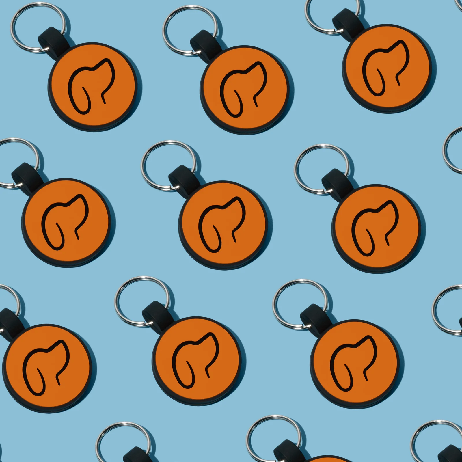 Round orange Truffle and Paw tags arranged in a repeating diagonal pattern against blue.