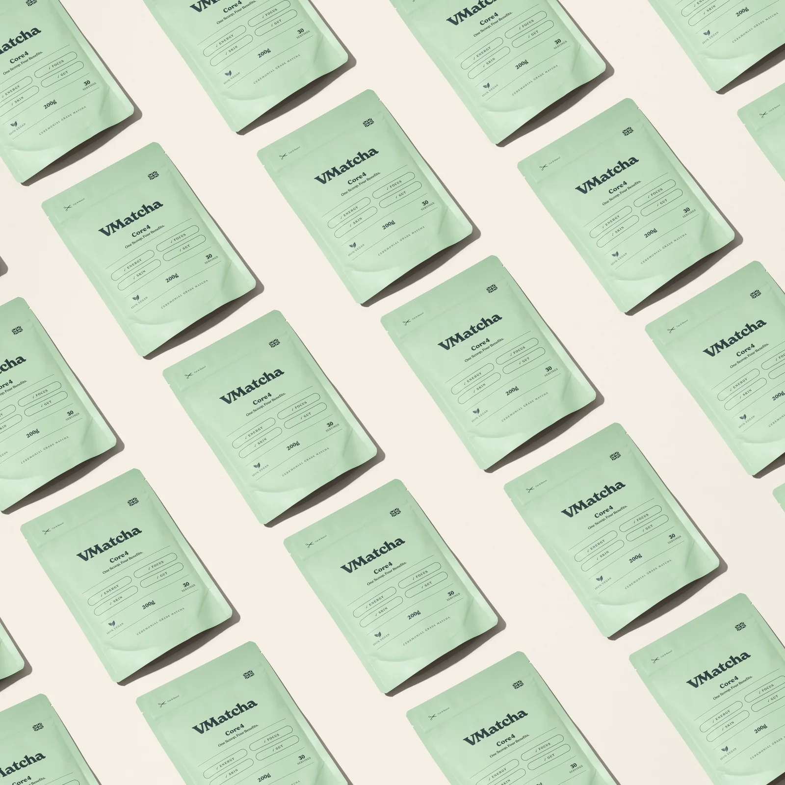 Pale green VMatcha Core4 pouches arranged in a repeating diagonal pattern on cream.