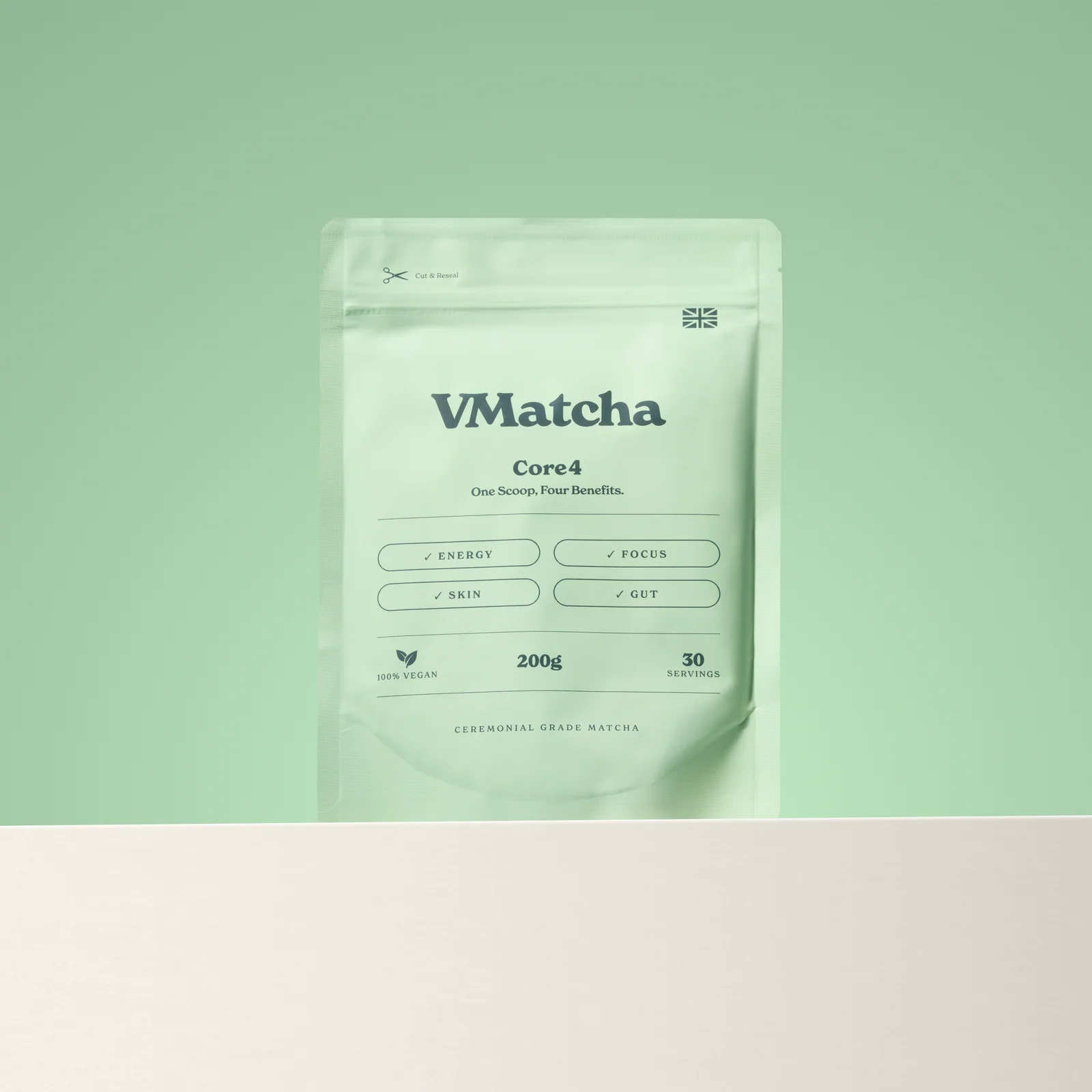 Pale green VMatcha Core4 pouch above a cream ledge against a matching green background.